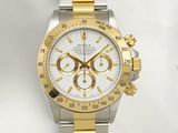 a gold and silver watch with a white face