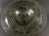 a silver plate with a candle inside of it on a table