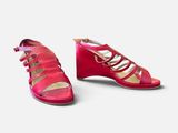 pair of women ' s red sandals on a white background