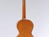 a close up of an acoustic guitar hanging from a string