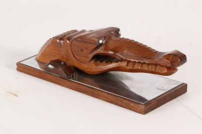 wooden sculpture of an elephant on a marble base on a white background
