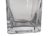 a clear glass vase with a silver lid on a white background