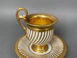 a cup and saucer on a saucer on a table