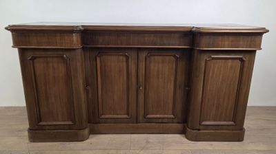 a close up of a wooden cabinet on a wooden floor