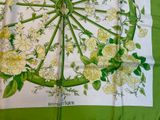 a green and white table cloth with flowers on it