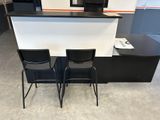 two chairs that are sitting in front of a counter