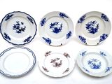 six blue and white plates with flowers on them on a white surface