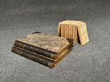 two books are stacked on top of each other on the floor