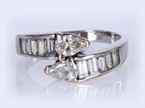 an image of a close up of a diamond ring on a white surface