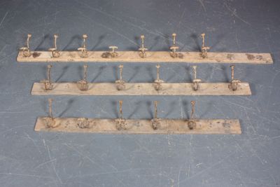 a lot of hooks on the wall that are attached to the wall