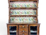 a wooden cabinet with a floral pattern on it