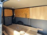 a van with plywood boards in the back of it