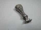 a silver spoon with a handle on a white table