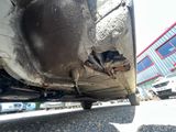 a close up of a car ' s rear end with a rusted tire