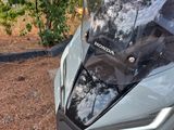 a close up of a motorcycle parked on the side of the road