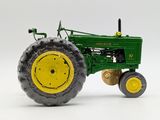 a toy tractor that is sitting on a white surface