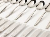 a lot of spoons that are lined up on the table