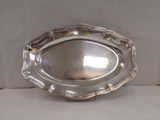 une assiette en argent ornée d'un motif décoratif sur le bord