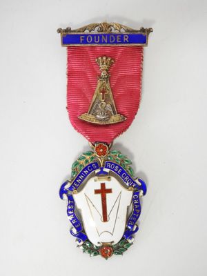 a medal with a cross on it and a ribbon around it