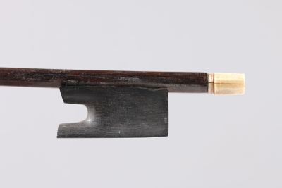 a close up of a knife with a wooden handle on a white surface