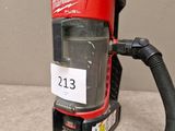 a red and black vacuum cleaner with a hose