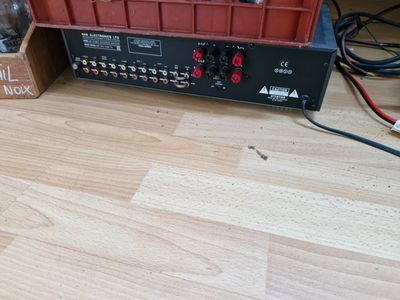 a picture of a wooden floor with a radio and a box