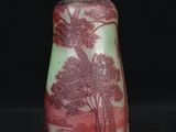an old fashioned lamp with a red and white design on it