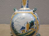 a vase with a picture on it sitting on a table
