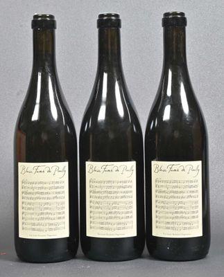 three bottles of wine sitting next to each other on top of a table