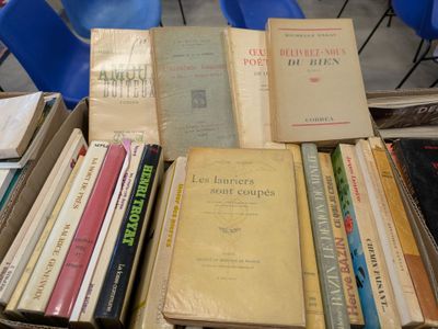several books are stacked on top of each other on a table
