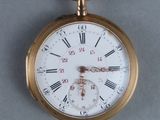 a gold pocket watch with roman numerals on it