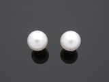 une paire de perles blanches sur un fond noir