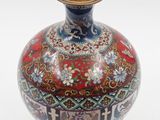a vase with a red and blue design on it