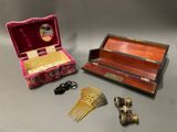 a small box with a comb, scissors, and other items on a table