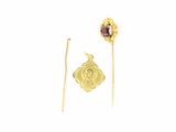 two pieces of gold and garnett on a white background