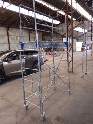 a car that is parked in a building with scaffolding around it