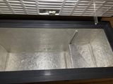 a metal box that is open on the floor