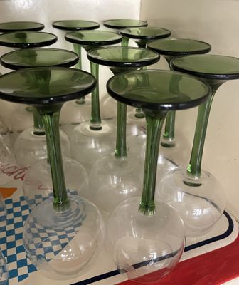 bottles and glasses are lined up on a tray in a kitchen