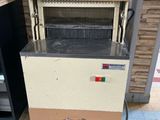 a machine that is sitting on the floor in the kitchen
