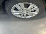 a man standing next to a car with a flat tire