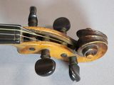 a close up of a violin that is on a table