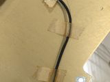 a guitar that is being worked on with a pair of pliers