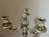 a silver candelab with three candles on it