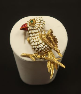 a small white box with a gold bird on it