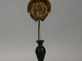 an image of a bronze sculpture of a bird on a black stand