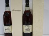 two bottles of wine sit next to a box of wine
