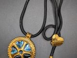 a close up of a necklace with a heart on it