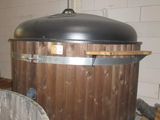 a large wooden barrel sitting on a pallet in a room