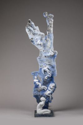 an image of a sculpture of a person on a rock