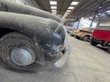 an old truck that is sitting in a garage
